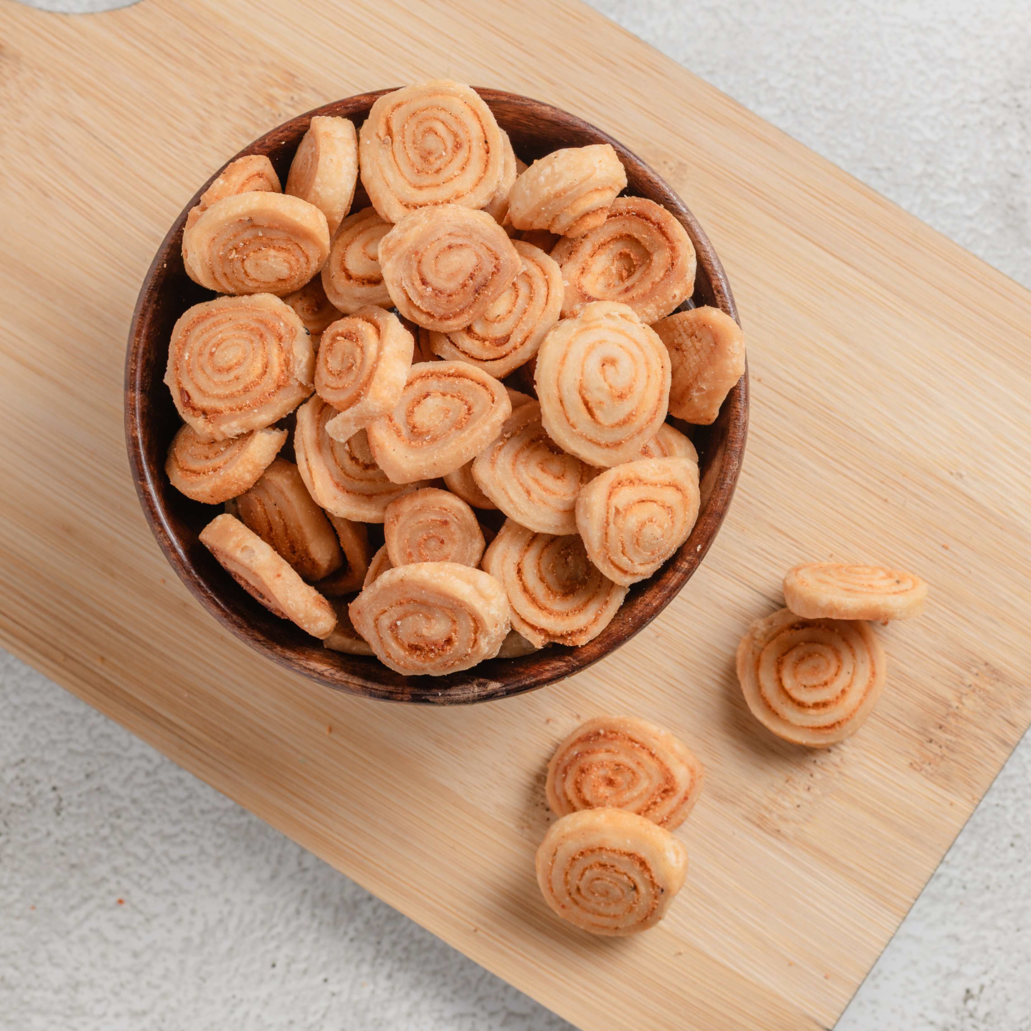 Buy crispy Bakarwadi online from World of Mysore Pak – golden, crunchy snack filled with tangy spices, perfect for teatime.