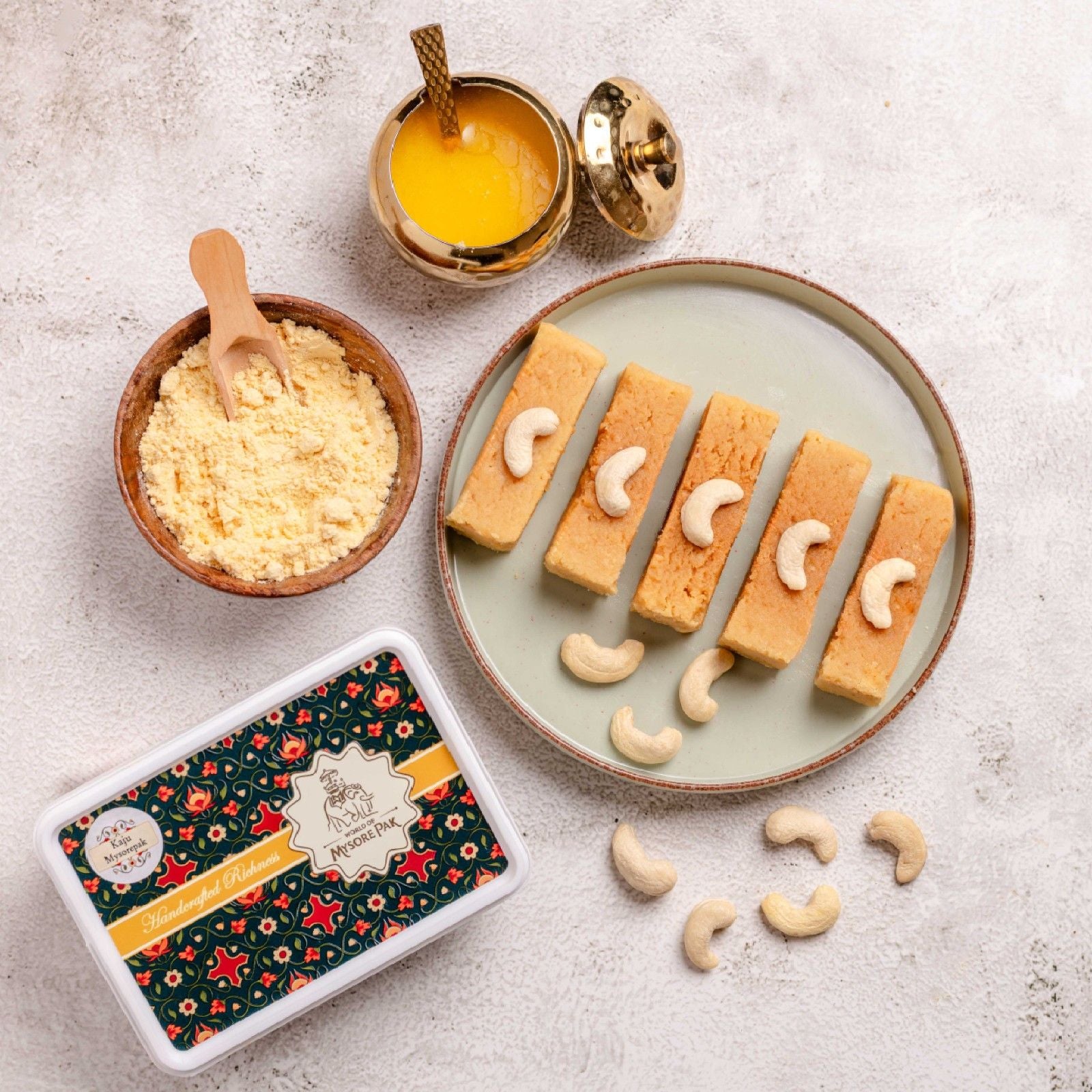 Buy cashew Mysore Pak online from World of Mysore Pak — a soft sweet made with pure ghee & a smooth kaju base.