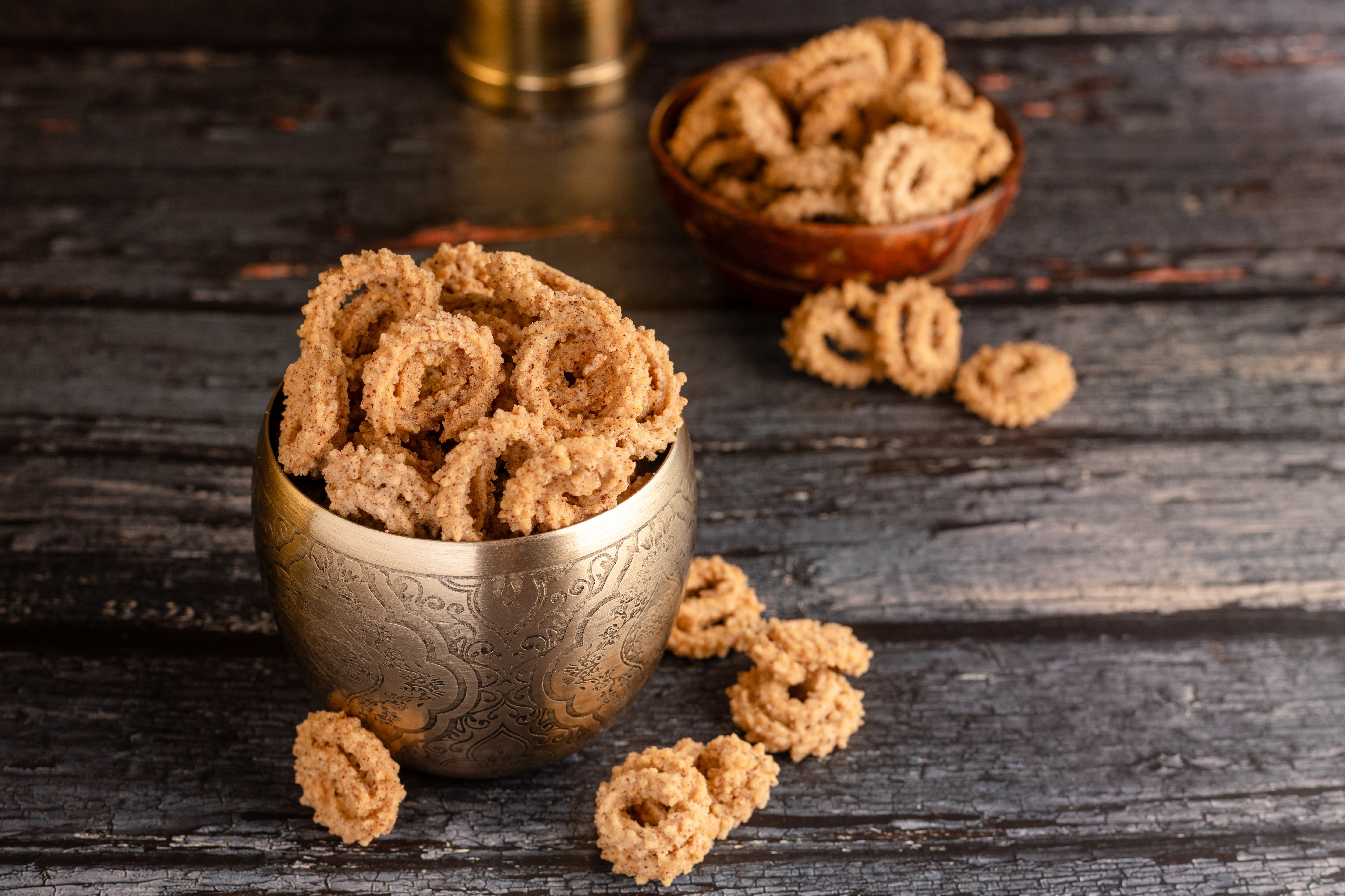 Buy Ragi Chakli snack online from World of Mysore Pak – crunchy, deep-fried millet snack with rustic flavor.