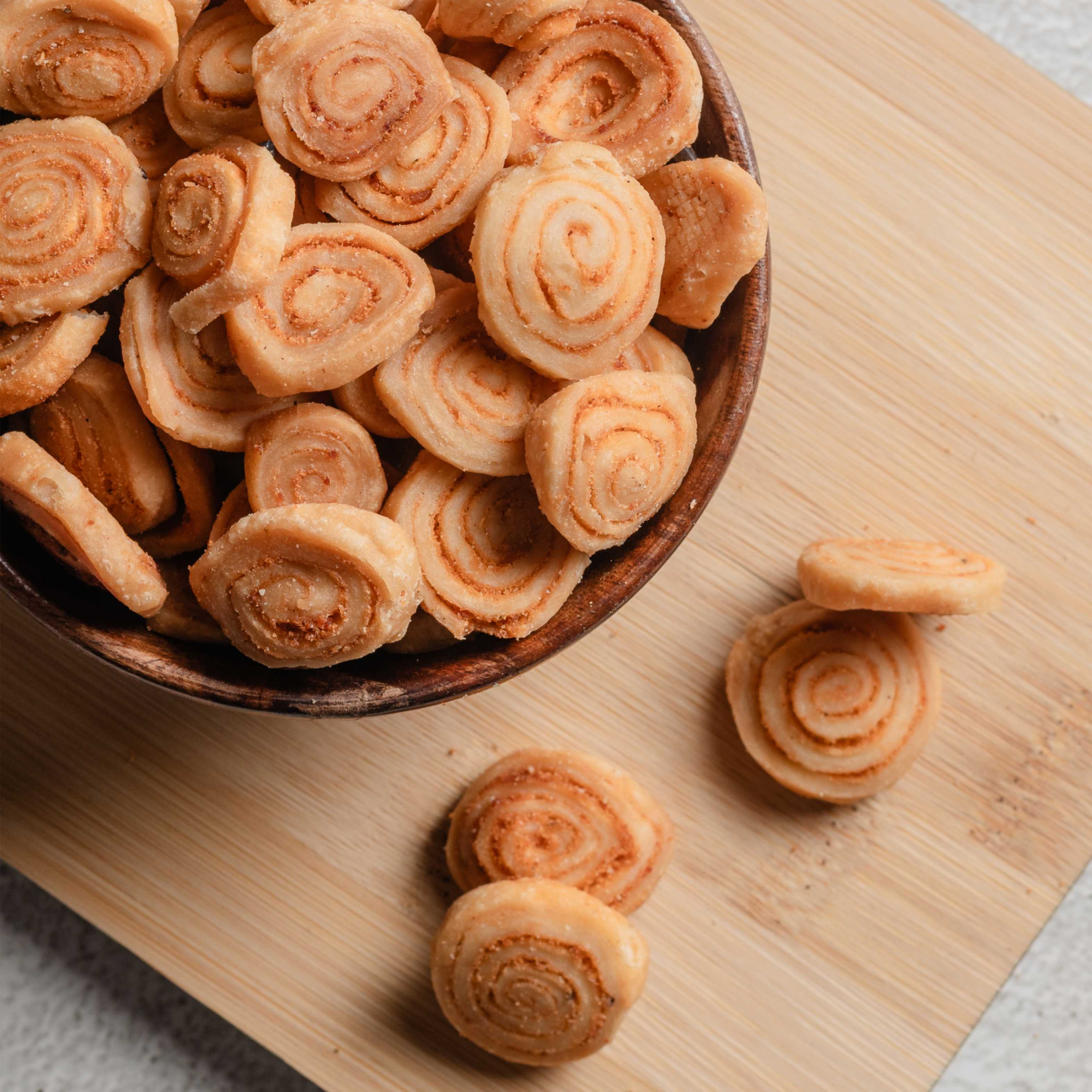 Buy Bhakharwadi food online from World of Mysore Pak – rolled, fried snack with sweet, spicy, and tangy flavors.