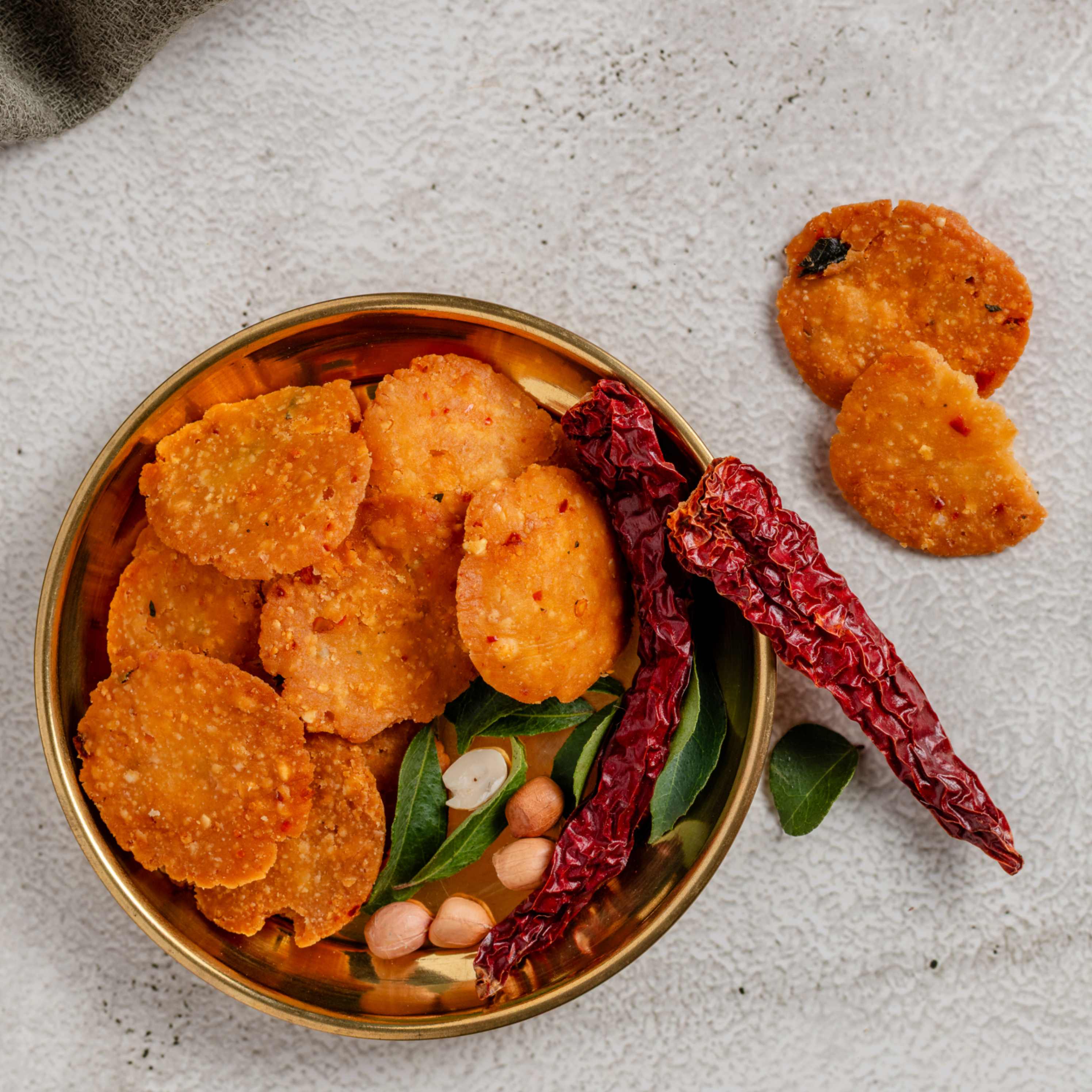 Buy crispy Nippattu online from World of Mysore Pak. A golden, crunchy snack made with peanuts.