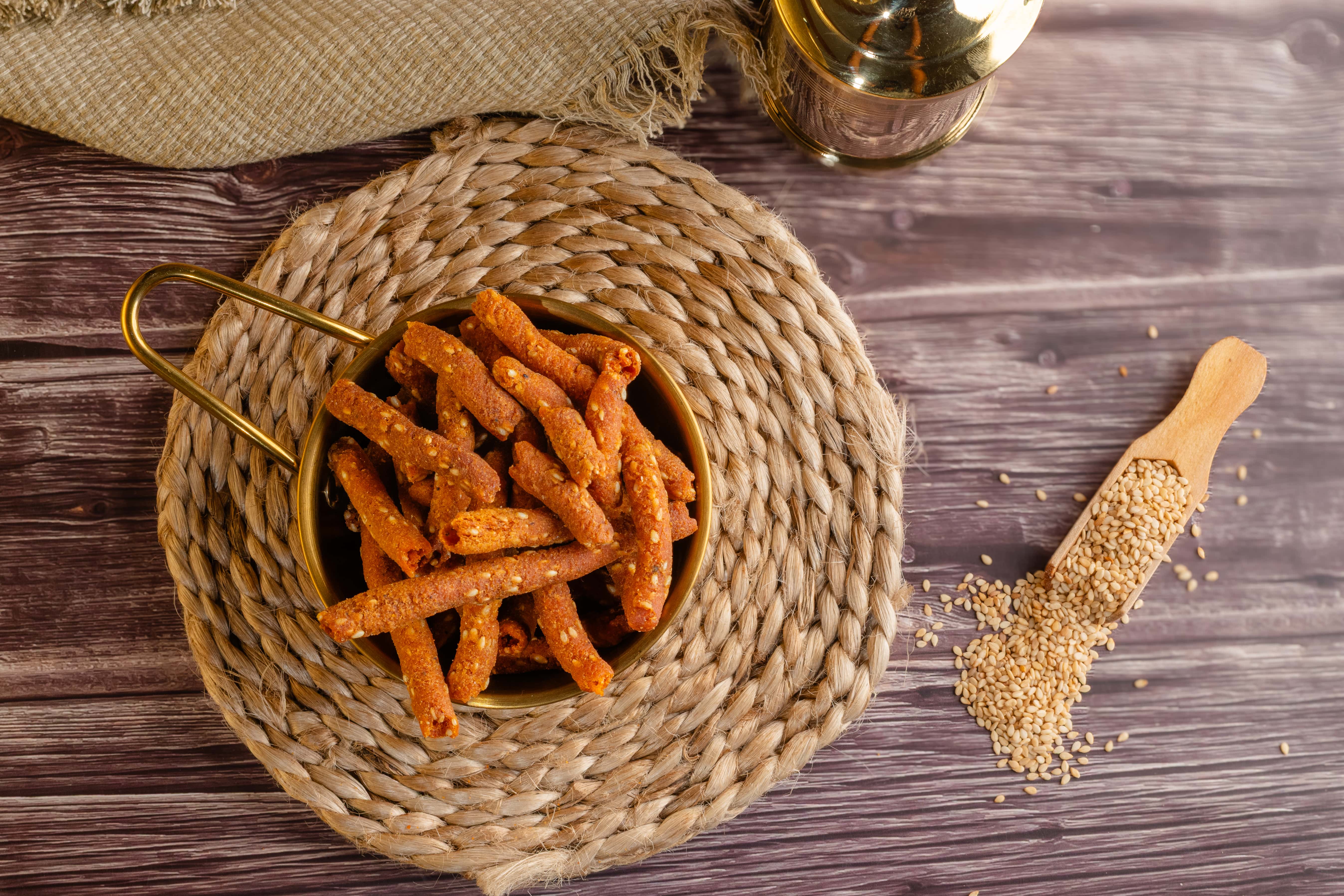Buy sesame sticks (Til Murukku) snacks online from World of Mysore Pak – rice flour & sesame seeds for a healthy, crunchy bite.