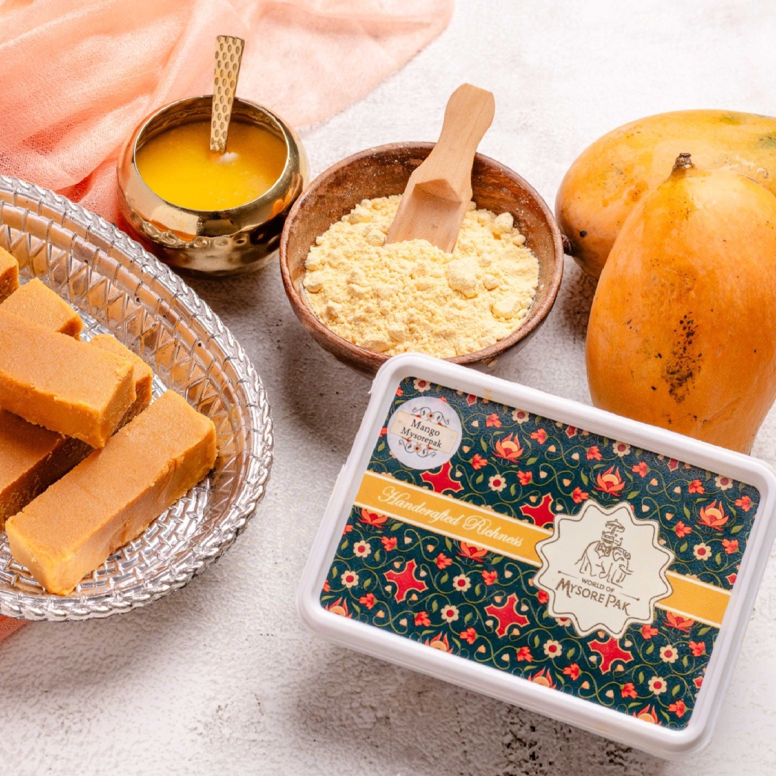 Buy Mango Mysore Pak online from World of Mysore Pak — rich ghee treat with fruity mango burst and soft texture.