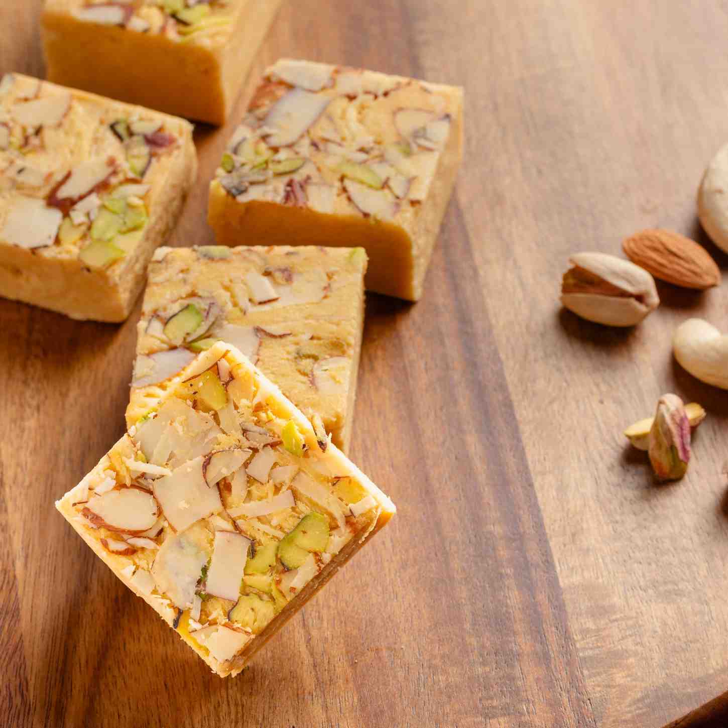 Buy pure ghee Soan Papdi online from World of Mysore Pak. A rich blend of besan, sugar, and ghee in every bite.