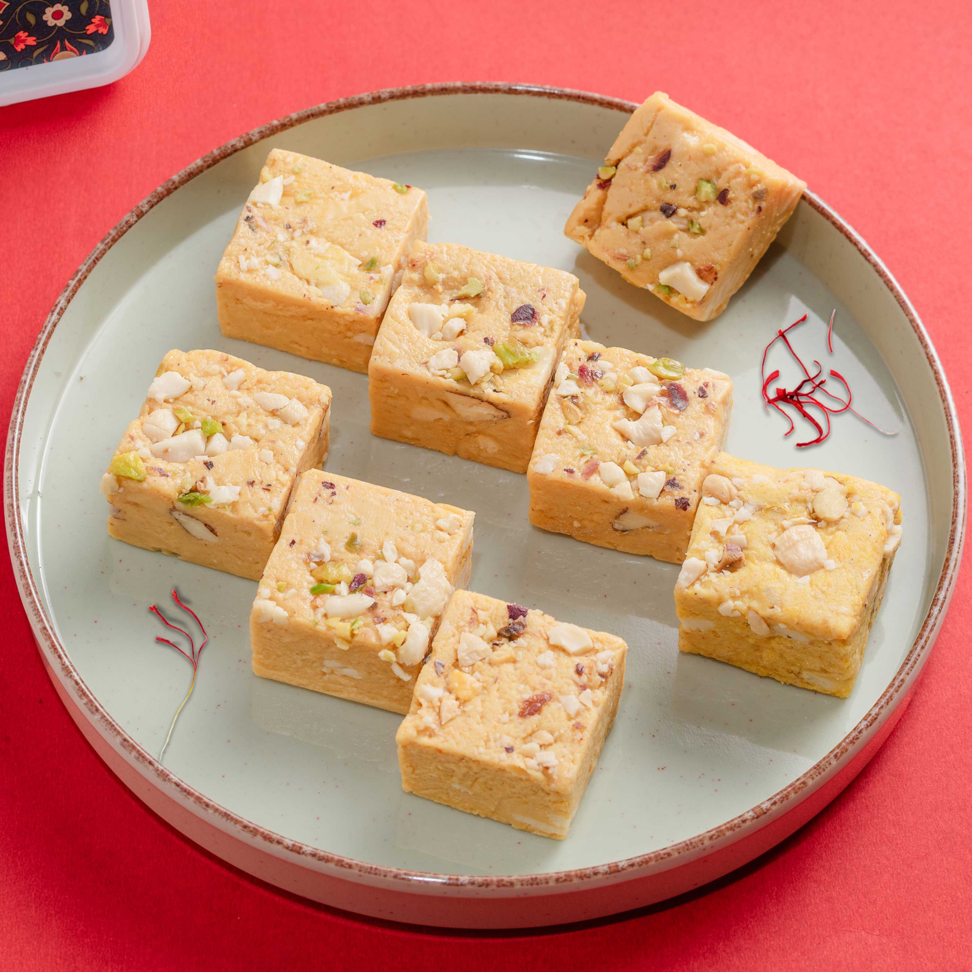 Buy Saffron Bites online from World of Mysore Pak — soft, ghee-filled bites with kesar and creamy cashew goodness.