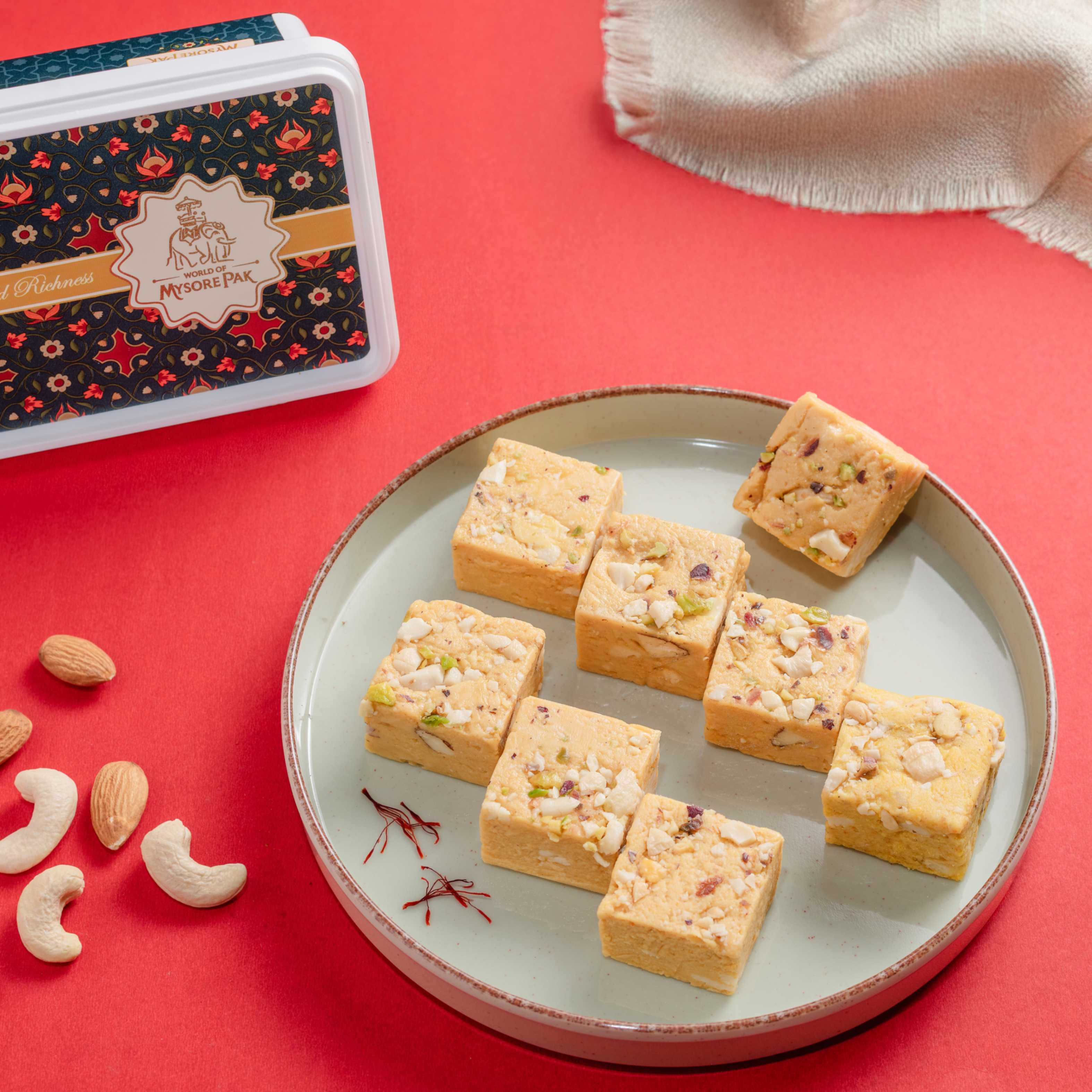Buy saffron-flavored ghee Kesar Bites sweets with kaju paste and caramel sugar online from World of Mysore Pak