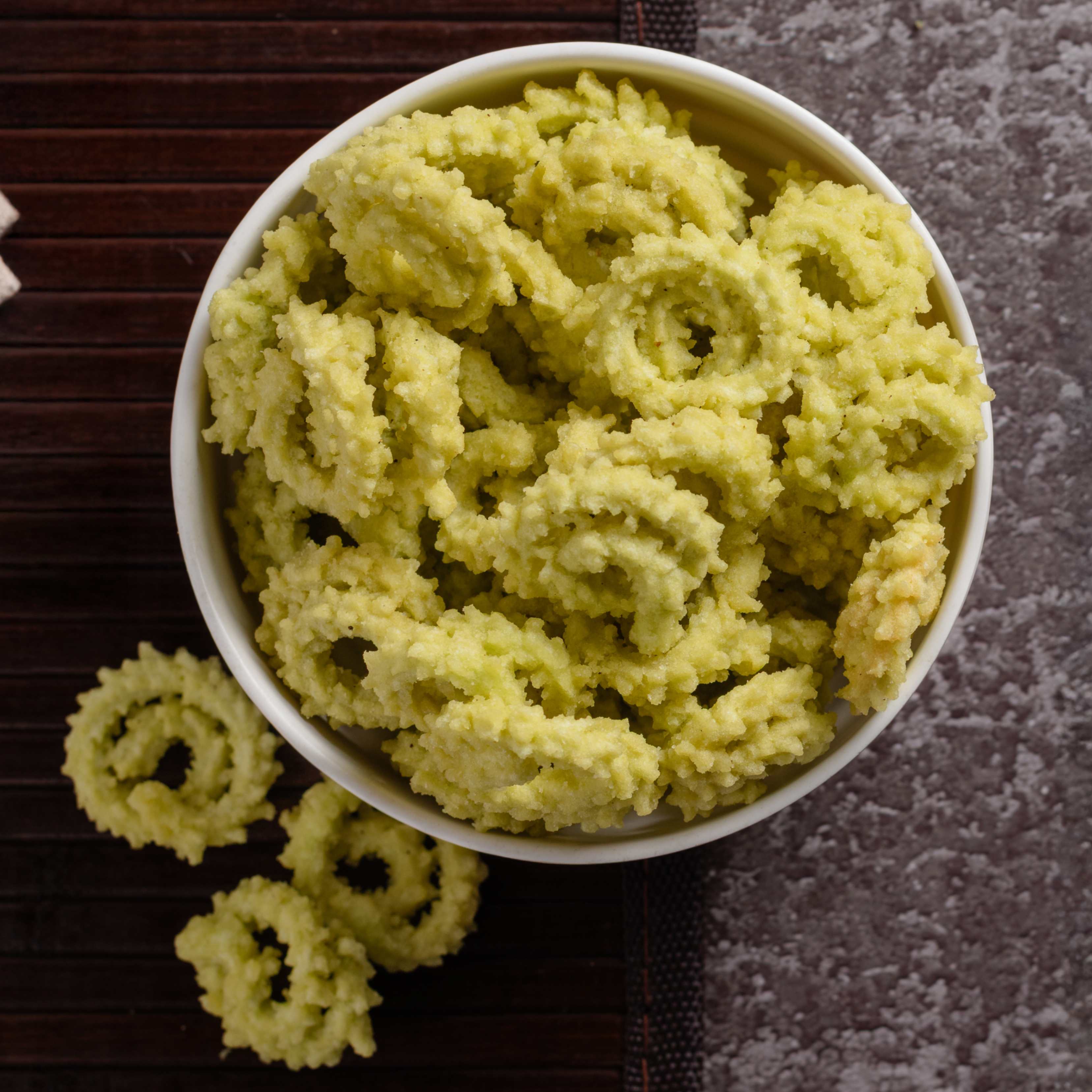 Buy Spinach Murukku online from World of Mysore Pak – crunchy murukku blended with the goodness of palak.