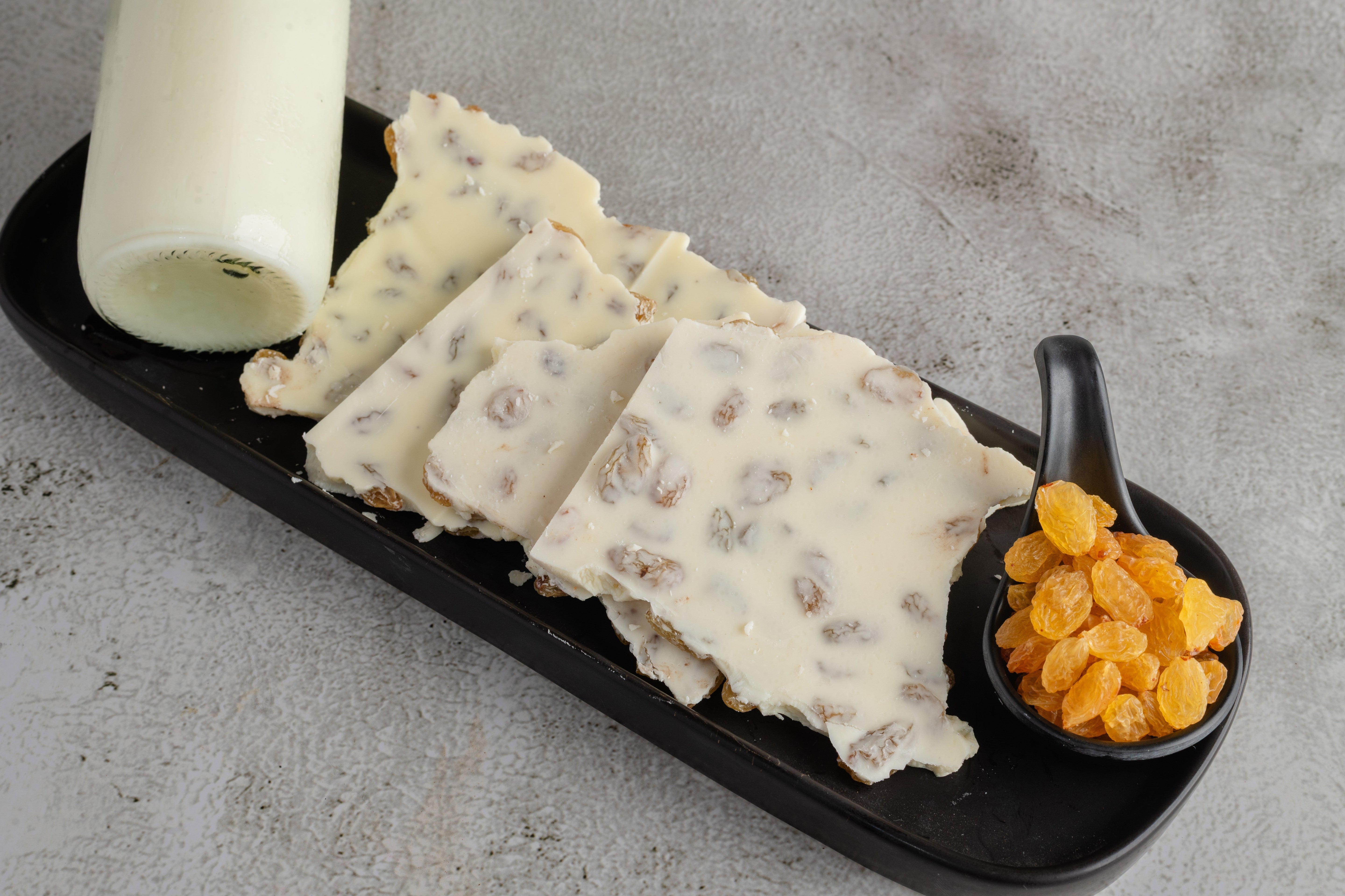 Buy White Chocolate Raisins—a daily sweet snack available online through World of Mysore Pak.